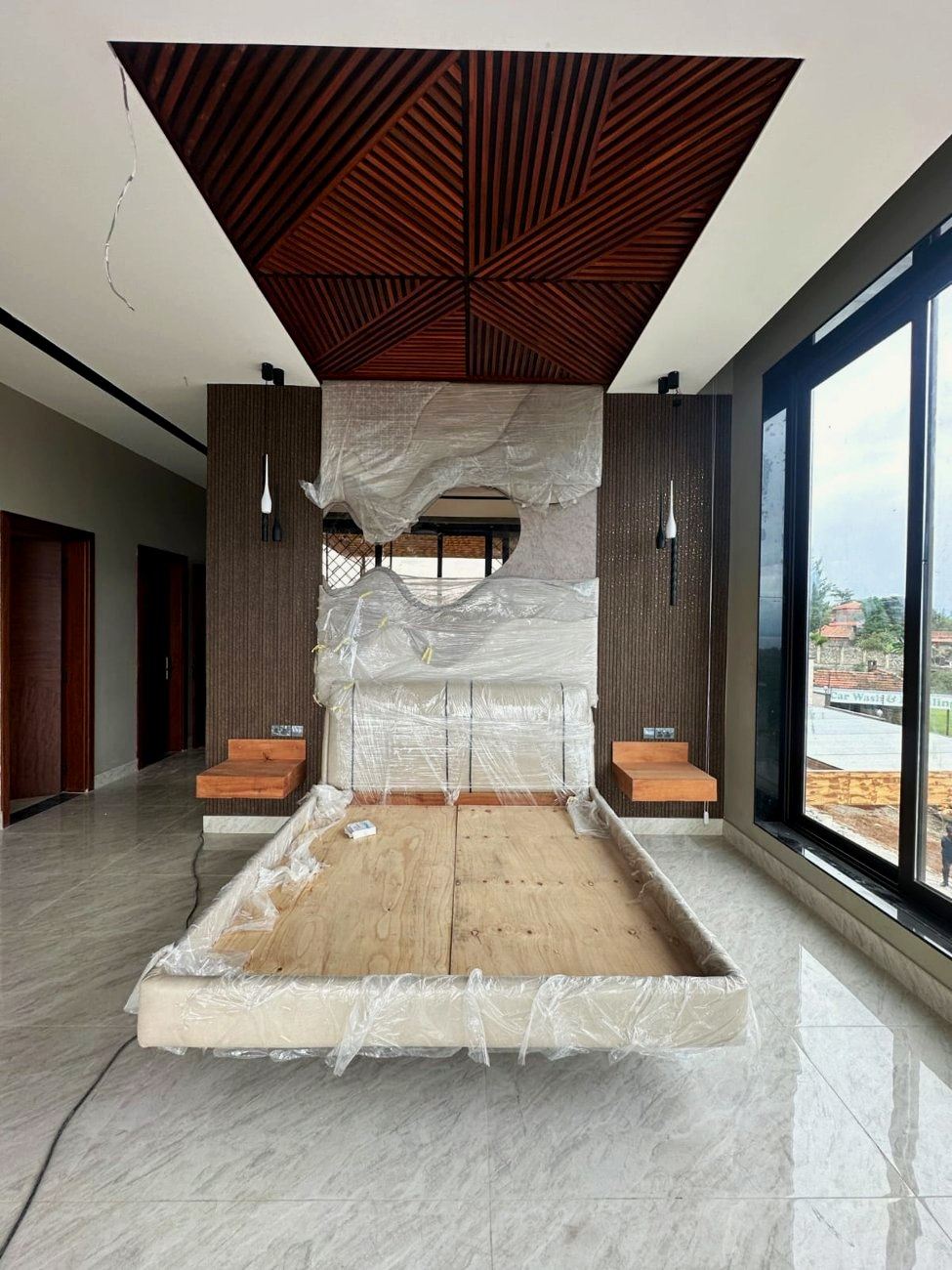 Floating bed mid-install with timber ceiling