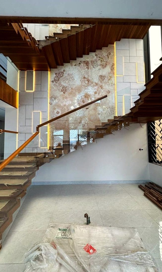 Floating staircase in engineered timber and glass with LED feature wall
