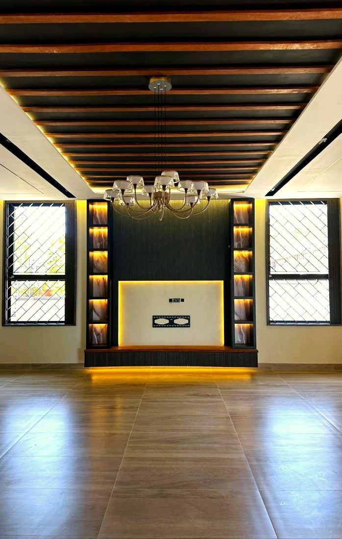 TV and media wall with timber ceiling and feature lighting