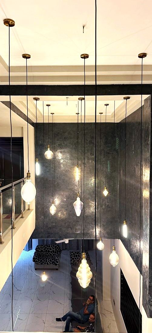 Penthouse double-height void with pendant lights, Migori