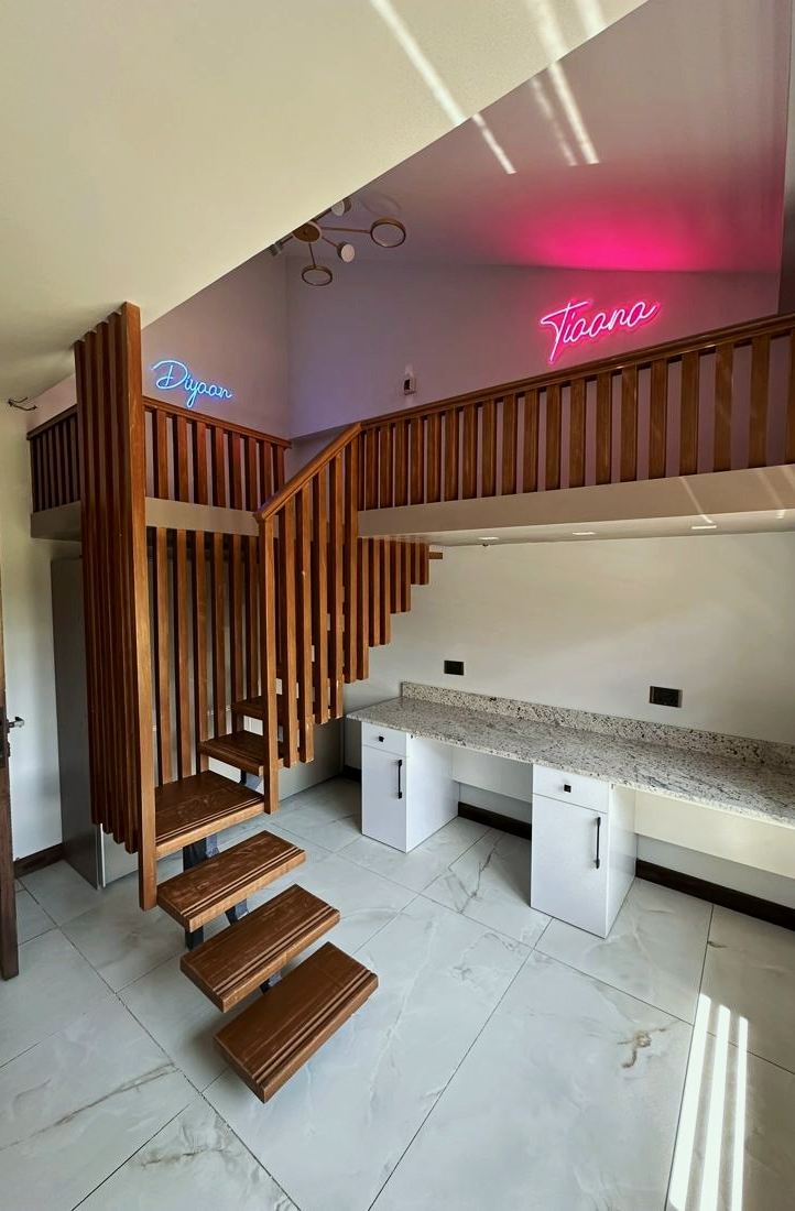 Themed kids' room with built-in timber stairs and bunk